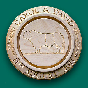 Centre engraving of a Beltie on a bread board